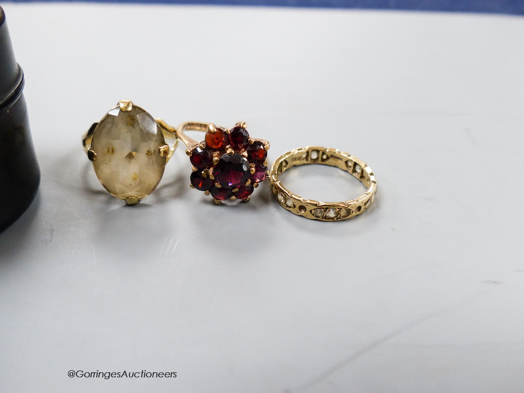 Three assorted 9ct gold and gem set rings, gross 8 grams.